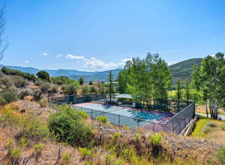 Enjoy outdoor recreation with this private tennis court, perfect for a friendly match or practice.