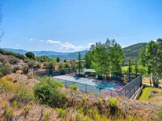 Enjoy outdoor recreation with this private tennis court, perfect for a friendly match or practice.