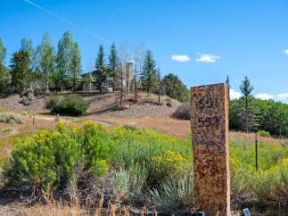 Discover this stunning property with a beautiful stone marker displaying house numbers 551 and 553.