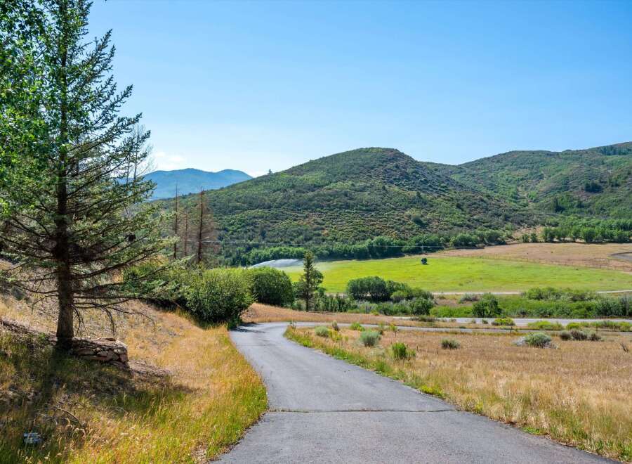 Discover this stunning property nestled amidst rolling green hills and lush trees.