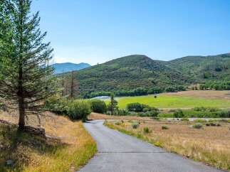 Discover this stunning property nestled amidst rolling green hills and lush trees.