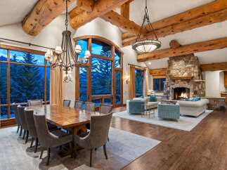 Experience rustic elegance in this stunning mountain lodge living and dining area.