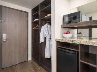 Discover modern convenience with this hotel room's built-in closet and kitchenette.