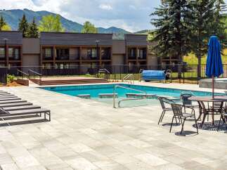 Enjoy a refreshing dip in the sparkling blue pool, surrounded by a spacious patio perfect for lounging.