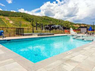 Enjoy a refreshing dip in this stunning outdoor swimming pool, perfect for relaxation and fun.