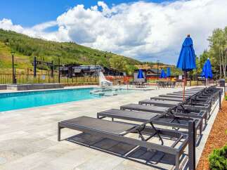 Experience luxury mountain living with this stunning outdoor pool and spa area, perfect for relaxation after a day of adventure.