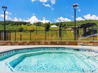 Enjoy a refreshing dip in this stunning outdoor hot tub, perfect for unwinding after a day on the slopes or exploring the scenic mountain landscape.