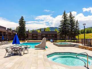 Enjoy a refreshing dip in the sparkling blue pool or relax in one of the inviting hot tubs at this stunning property.