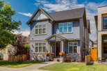 Discover this stunning two-story home featuring a charming blue stucco exterior complemented by stone accents.