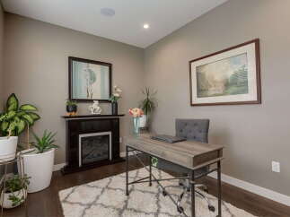 This home office features a cozy electric fireplace, perfect for creating a warm and inviting atmosphere for work or relaxation.