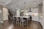 Experience modern living in this stunning kitchen featuring a spacious island with bar seating, perfect for casual dining and entertaining.