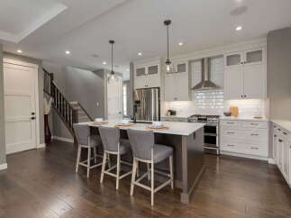 Experience modern living in this stunning kitchen featuring a spacious island with bar seating, perfect for casual dining and entertaining.
