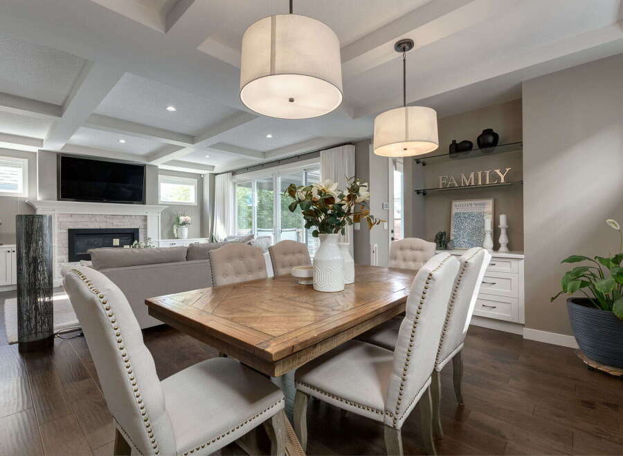 Experience elegant open-concept living in this stunning home, featuring a spacious dining area perfect for gatherings and a cozy living room with a fireplace.