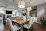 Experience elegant open-concept living in this stunning home, featuring a spacious dining area perfect for gatherings and a cozy living room with a fireplace.