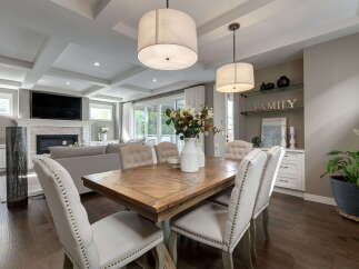 Experience elegant open-concept living in this stunning home, featuring a spacious dining area perfect for gatherings and a cozy living room with a fireplace.