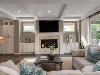 Experience modern living in this beautifully appointed living room, featuring a stunning stone fireplace as the focal point.