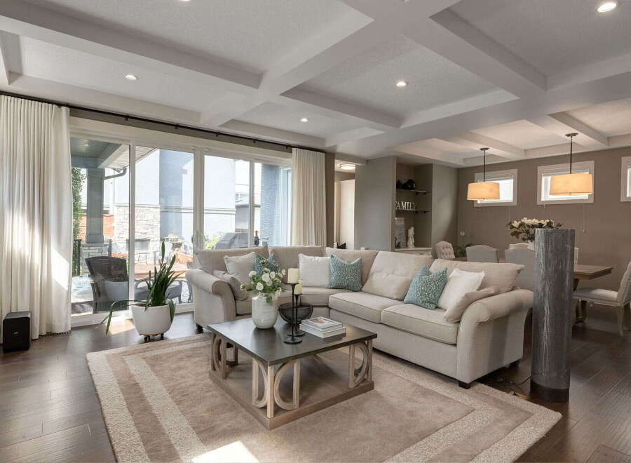 Experience luxurious living in this spacious great room, featuring a large sectional sofa perfect for gatherings.