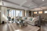 Experience luxurious living in this spacious great room, featuring a large sectional sofa perfect for gatherings.
