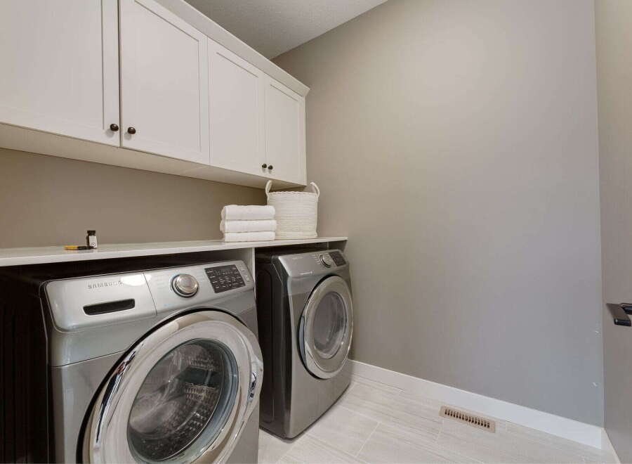 This laundry room features a stacked Samsung washer and dryer set, maximizing space and efficiency.