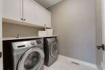 This laundry room features a stacked Samsung washer and dryer set, maximizing space and efficiency.