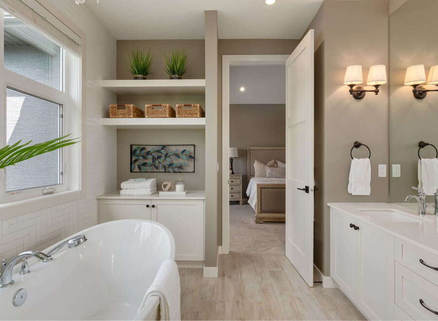 Experience luxury in this stunning bathroom featuring a freestanding soaking tub and a spacious vanity with dual sinks.
