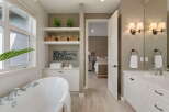 Experience luxury in this stunning bathroom featuring a freestanding soaking tub and a spacious vanity with dual sinks.