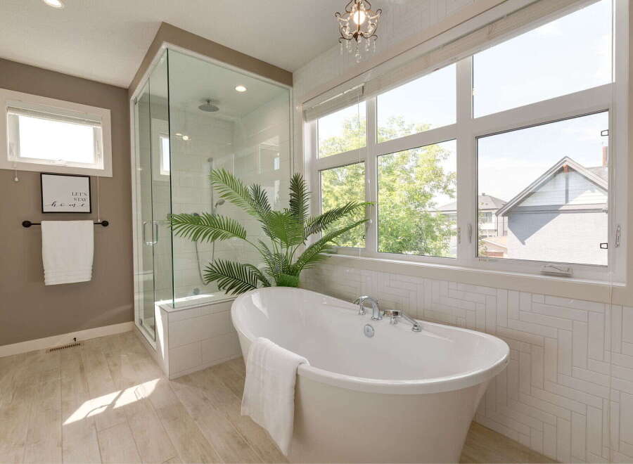 Experience luxury in this stunning bathroom featuring a freestanding soaking tub and a spacious glass-enclosed shower.