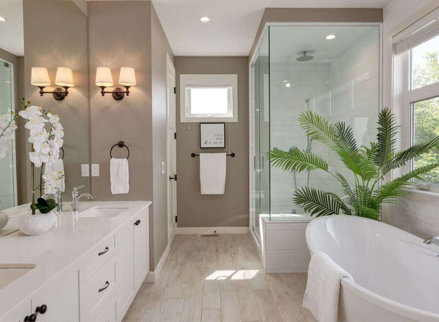 Experience luxury in this stunning bathroom featuring a freestanding soaking tub and a spacious glass-enclosed shower.