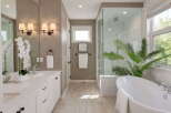 Experience luxury in this stunning bathroom featuring a freestanding soaking tub and a spacious glass-enclosed shower.