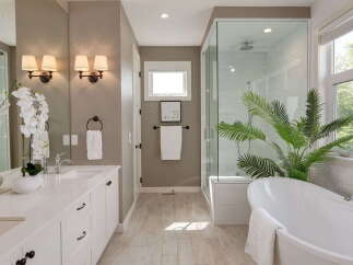 Experience luxury in this stunning bathroom featuring a freestanding soaking tub and a spacious glass-enclosed shower.