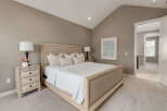 Experience ultimate comfort in this serene bedroom, featuring a plush king-size bed adorned with soft linens and decorative pillows.