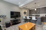 Experience modern living in this open-concept condo featuring a sleek kitchen with stainless steel appliances and a breakfast bar perfect for casual dining.