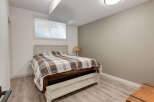 Discover comfort and style in this inviting bedroom, featuring a cozy bed with a classic plaid comforter.