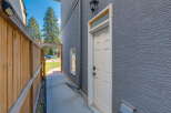 Discover this charming property featuring a private wooden fence leading to a side entrance.