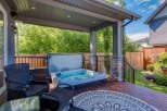 Enjoy ultimate relaxation in this covered backyard oasis, featuring a luxurious hot tub perfect for unwinding.