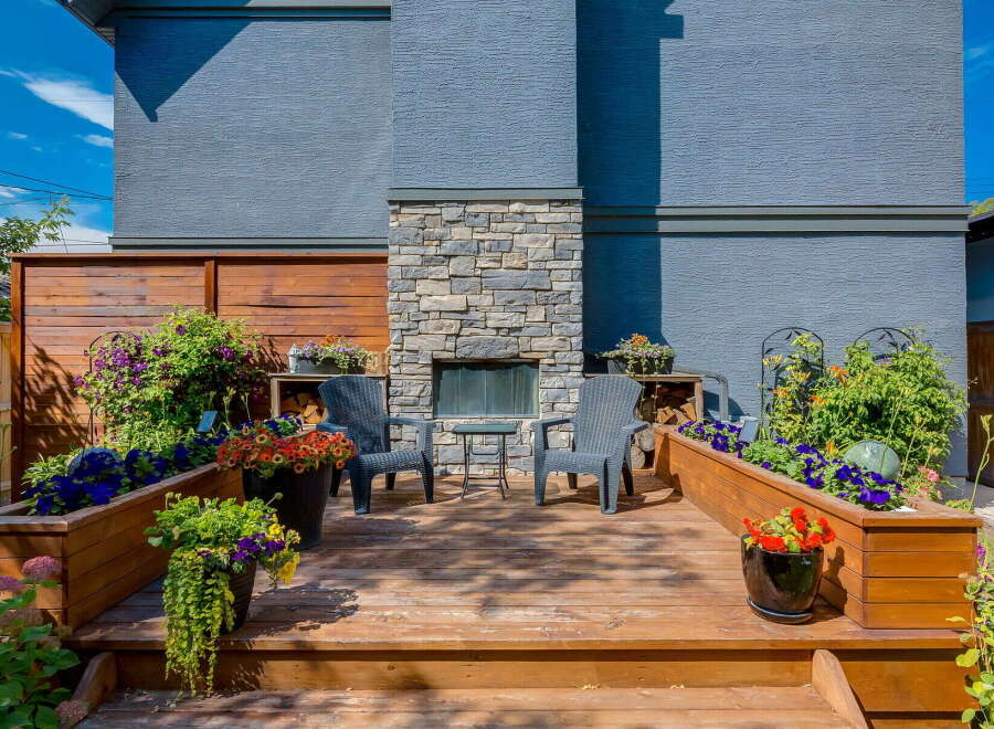 Experience outdoor living at its finest on this beautifully appointed deck, complete with a stone-clad fireplace and comfortable seating.