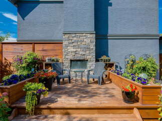 Experience outdoor living at its finest on this beautifully appointed deck, complete with a stone-clad fireplace and comfortable seating.