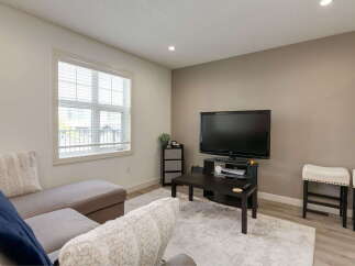 Step into this inviting living room, featuring a comfortable sectional sofa perfect for relaxation and entertainment.