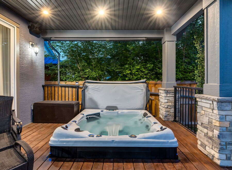 Relax and unwind in this luxurious backyard oasis, featuring a spacious hot tub perfect for year-round enjoyment.