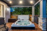 Relax and unwind in this luxurious backyard oasis, featuring a spacious hot tub perfect for year-round enjoyment.