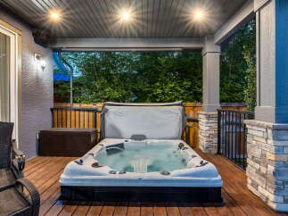 Relax and unwind in this luxurious backyard oasis, featuring a spacious hot tub perfect for year-round enjoyment.