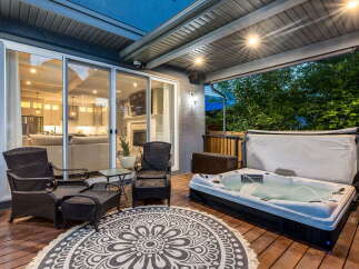 Enjoy ultimate relaxation on this spacious deck, featuring a luxurious hot tub perfect for unwinding.