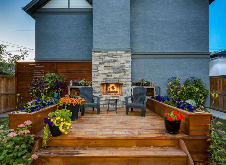 Experience outdoor living at its finest with this beautifully designed deck featuring a stunning stone fireplace, perfect for cozy evenings.