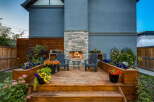 Experience outdoor living at its finest with this beautifully designed deck featuring a stunning stone fireplace, perfect for cozy evenings.