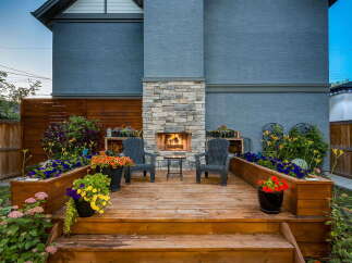 Experience outdoor living at its finest with this beautifully designed deck featuring a stunning stone fireplace, perfect for cozy evenings.