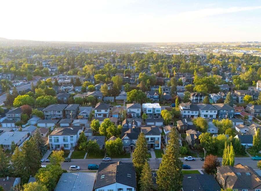 Discover this charming suburban neighborhood, bathed in the warm glow of a setting sun.