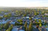 Discover this charming suburban neighborhood, bathed in the warm glow of a setting sun.