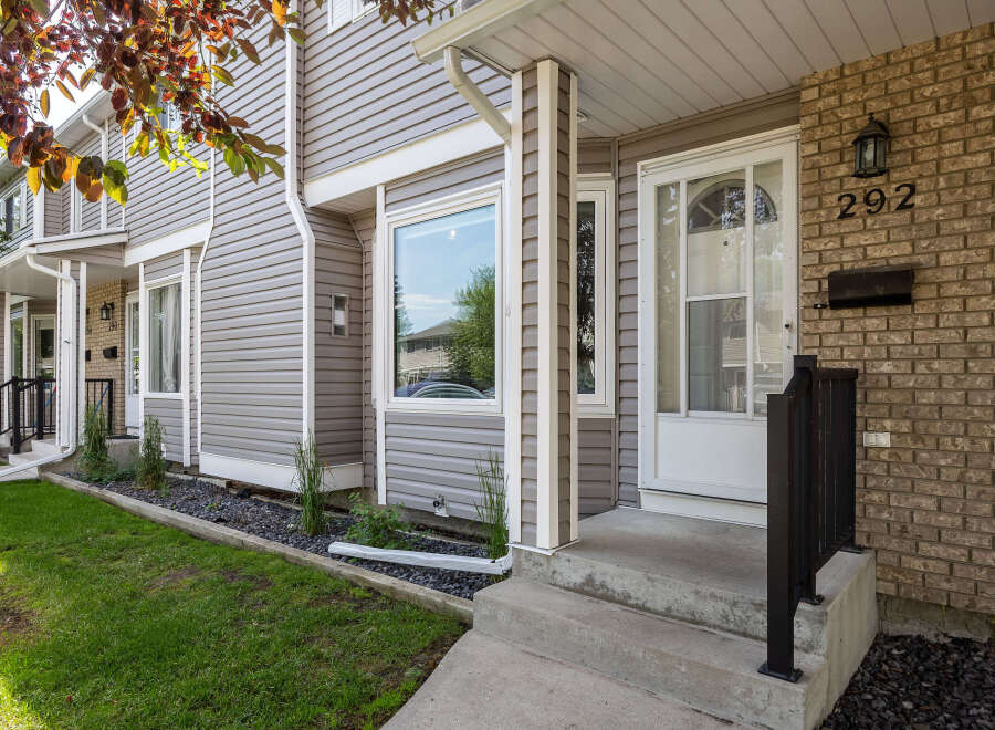Charming townhouse exterior featuring a welcoming brick facade with house number 292.
