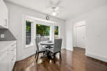 Bright and airy dining area featuring a charming bay window with lush green views.