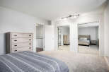 Discover this spacious master bedroom featuring a large dresser and ample closet space with mirrored sliding doors.